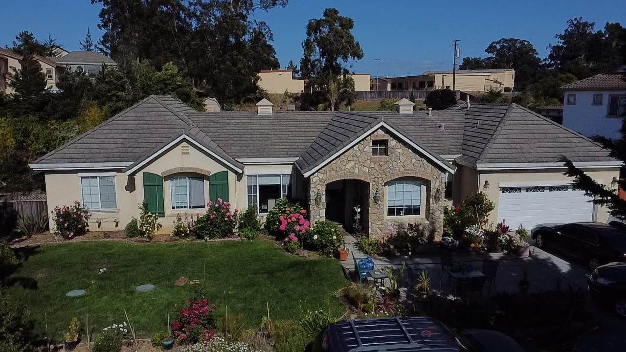 Gray Tile Reroof on a Stucco Home with Stone Arched Entry