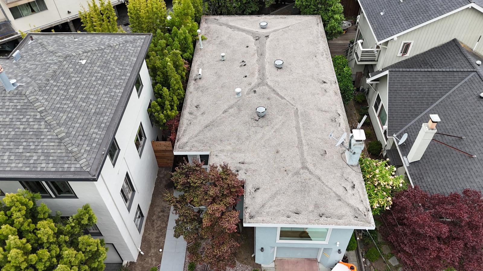 White Flat Roof Replacement on a Blue-Green Home — before